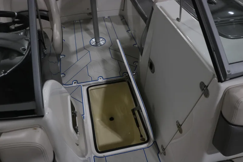 Slide: The Image of 2009 Yamaha Boats 212X interior showing open storage compartment and seating area. - 20
