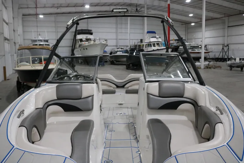 Slide: The Image of 2009 Yamaha Boats 212X interior in a spacious indoor storage facility. - 4