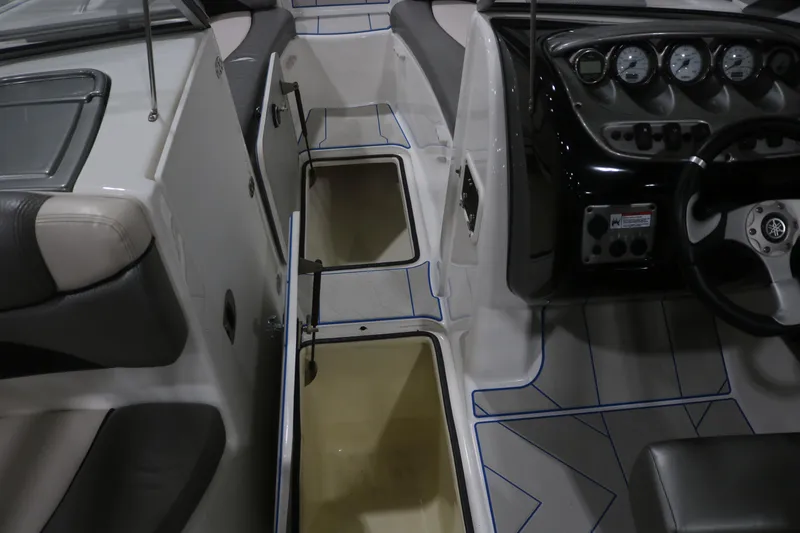 Slide: The Image of 2009 Yamaha Boats 212X interior showing dashboard, seating, and storage compartments. - 21