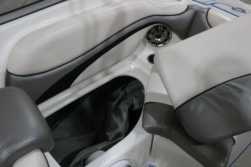 Slide: The Image of Interior seating and storage of a 2009 Yamaha Boats 212X, featuring sleek design and speaker. - 27