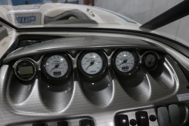 Slide: The Image of Dashboard of a 2009 Yamaha Boats 212X, featuring gauges and controls. - 15