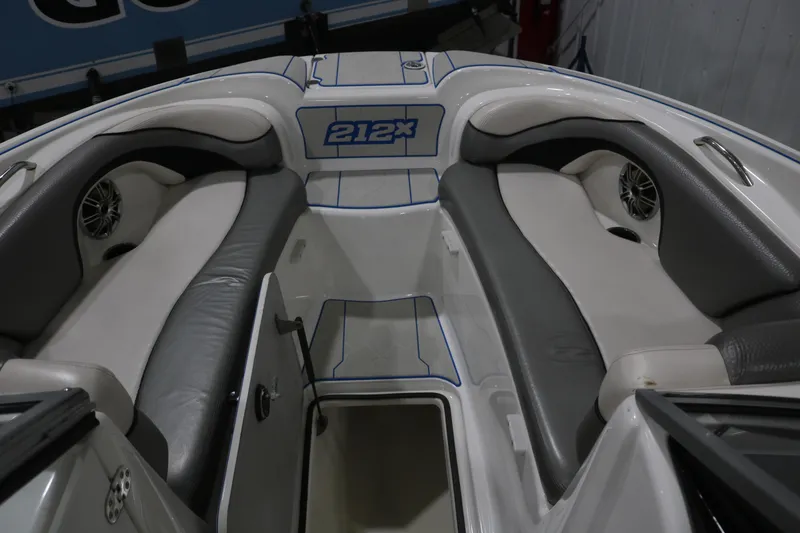 Slide: The Image of Interior of a 2009 Yamaha Boats 212X, featuring cushioned seating and speaker system. - 18