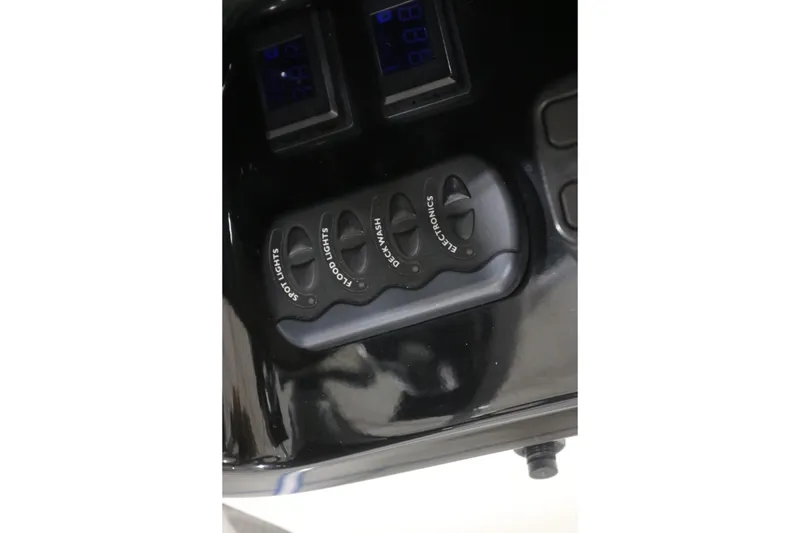 Slide: The Image of Control panel of a 2009 Yamaha Boats 212X with labeled switches and displays. - 26