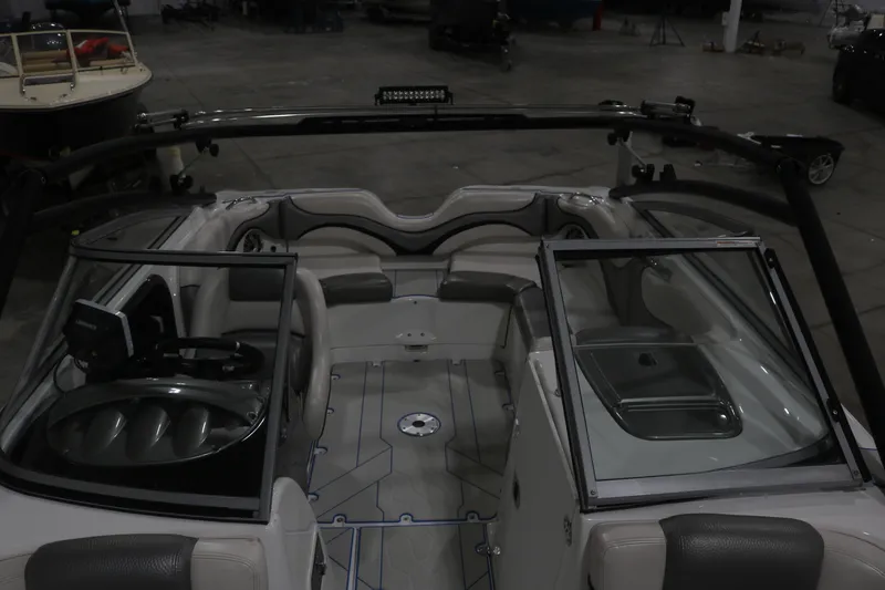 Slide: The Image of 2009 Yamaha Boats 212X interior with steering wheel and seating in a showroom. - 12