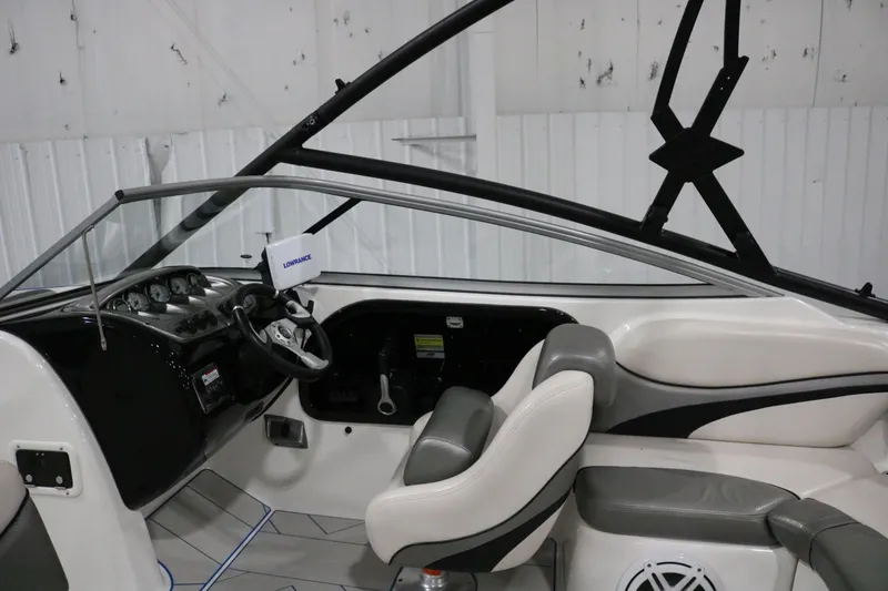 Slide: The Image of Interior of a 2009 Yamaha Boats 212X, featuring steering wheel and seating. - 32