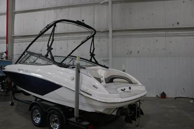 Slide: The Image of 2009 Yamaha Boats 212X in a warehouse, featuring a sleek design and twin engines. - 1