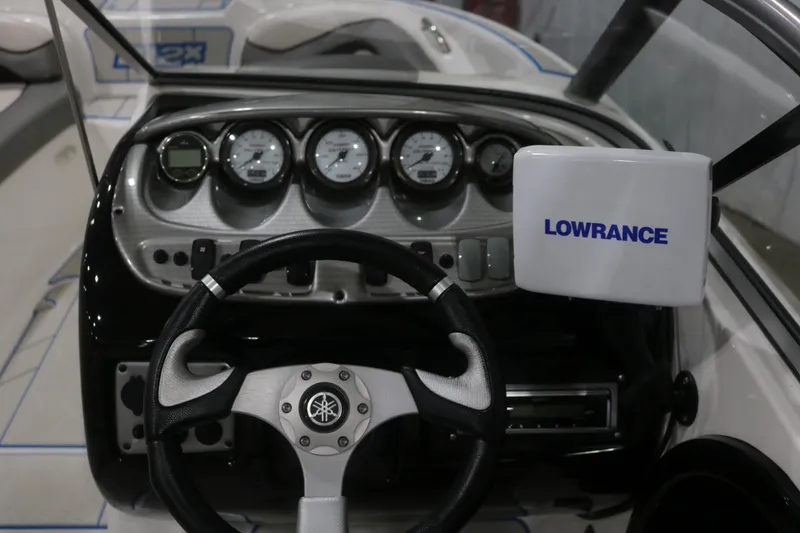 Slide: The Image of 2009 Yamaha Boats 212X dashboard with steering wheel and Lowrance navigation system. - 11
