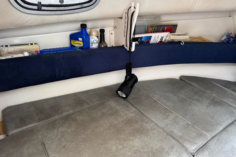 Slide: The Image of Interior cabin of a 1999 Boston Whaler 21 Conquest with storage and flashlight. - 9