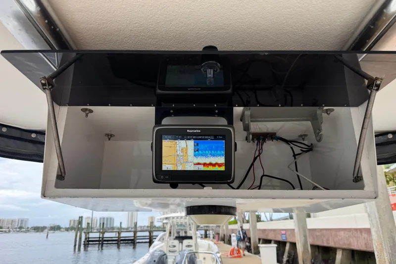 Slide: The Image of 1999 Boston Whaler 21 Conquest boat dashboard with Raymarine navigation system. - 7