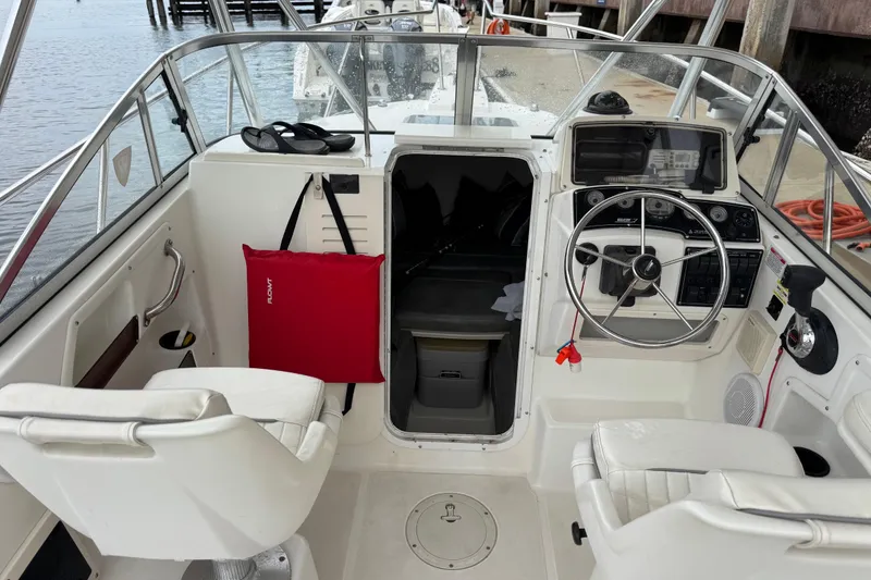 Slide: The Image of 1999 Boston Whaler 21 Conquest boat interior with steering wheel and seating. - 5