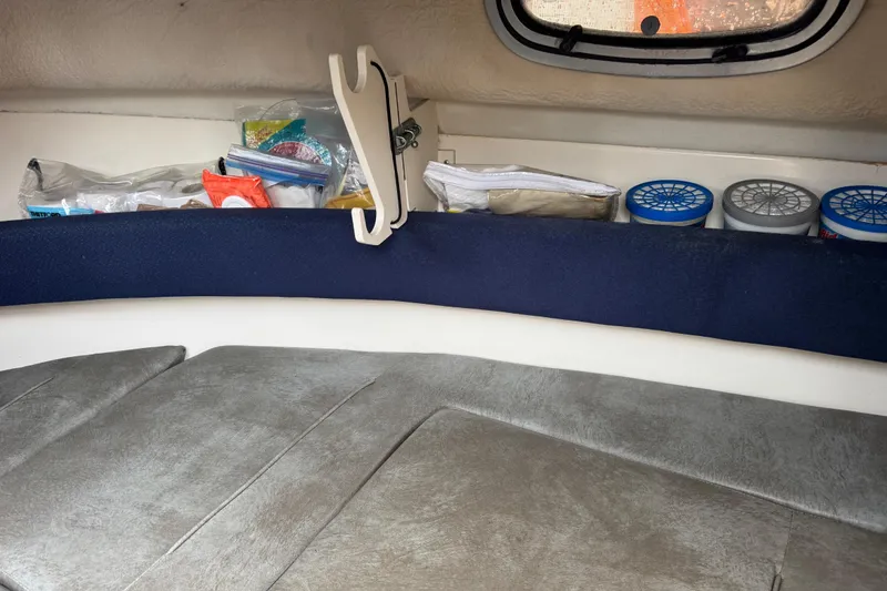 Slide: The Image of Interior cabin storage of a 1999 Boston Whaler 21 Conquest boat with organized supplies. - 10