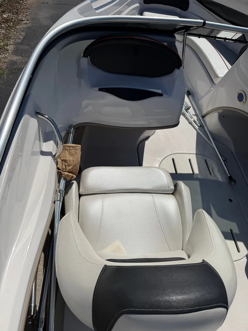 Slide: The Image of The image shows the interior of a 2013 Four Winns 190 SS boat with white seating. - 7