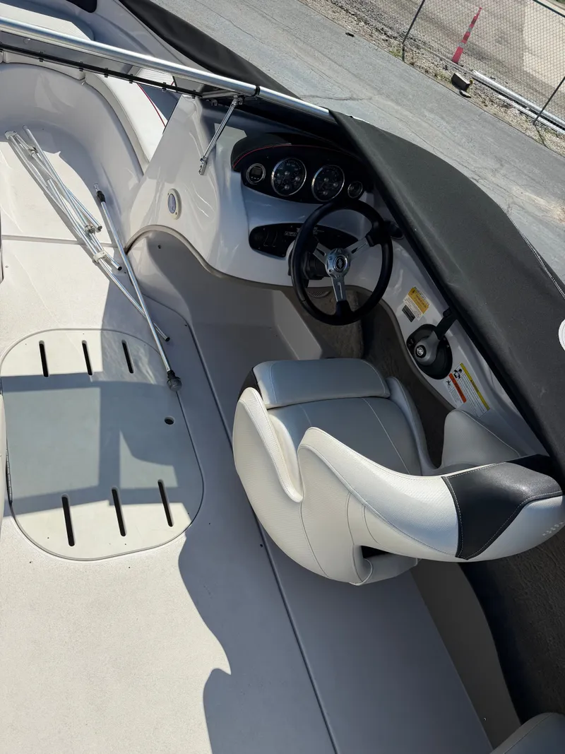 Slide: The Image of The image shows the cockpit of a 2013 Four Winns 190 SS boat with a white seat and black steering wheel. - 8