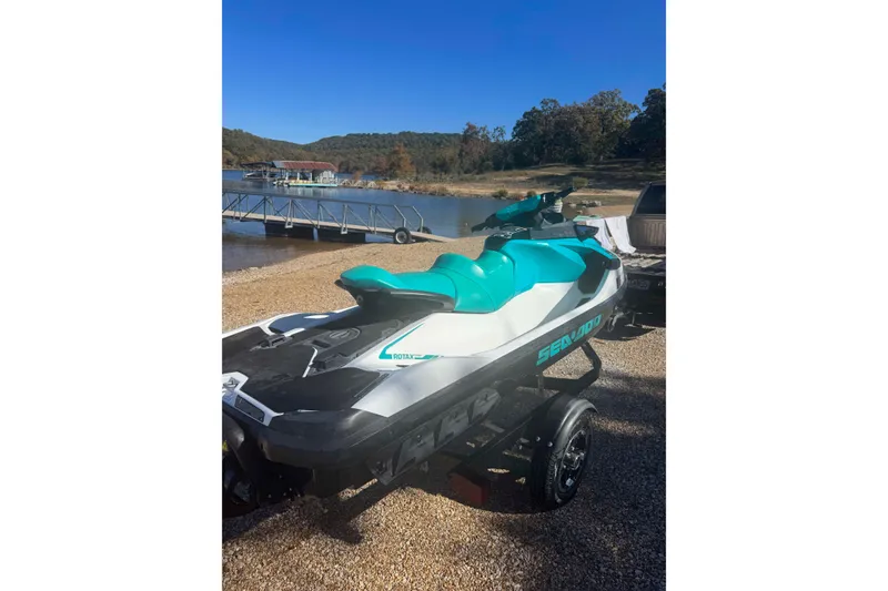 Slide: The Image of 2022 Sea-Doo GTI SE 130 jet ski on trailer by a lakeside dock. - 5
