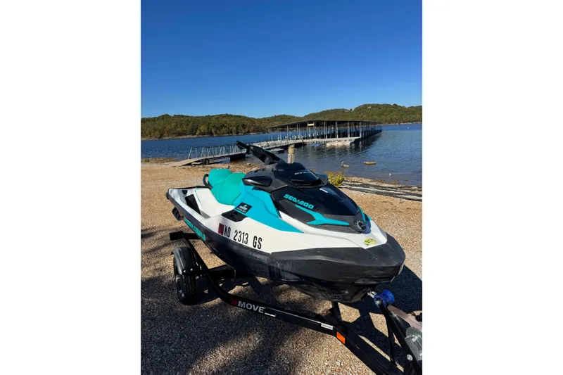 The Image of 2022 Sea-Doo GTI SE 130 jet ski on trailer by a scenic lake. - 0