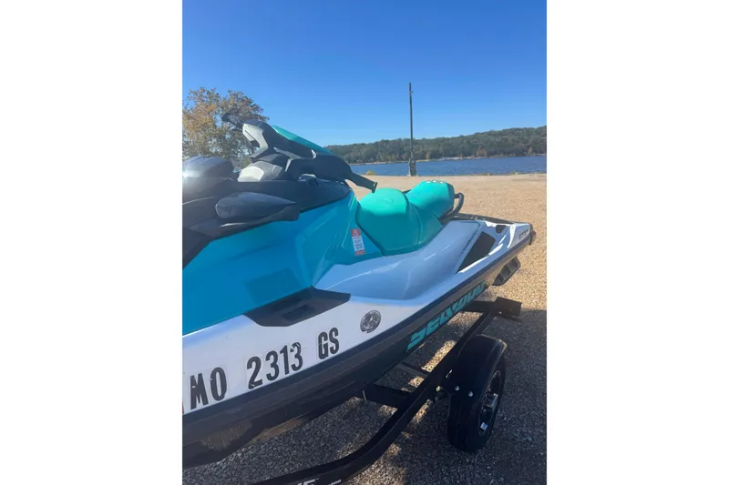 Slide: The Image of 2022 Sea-Doo GTI SE 130 jet ski on trailer by a lake. - 3