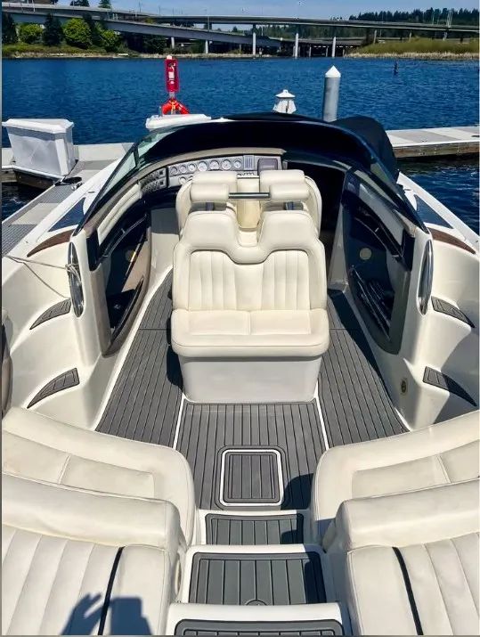 Slide: The Image of The image shows the cockpit of a 2005 Cobalt 343 boat with white leather seats and gray flooring. - 14
