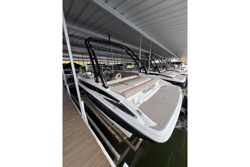 Slide: The Image of 2019 Crownline 215 SS boat docked under covered marina. - 4