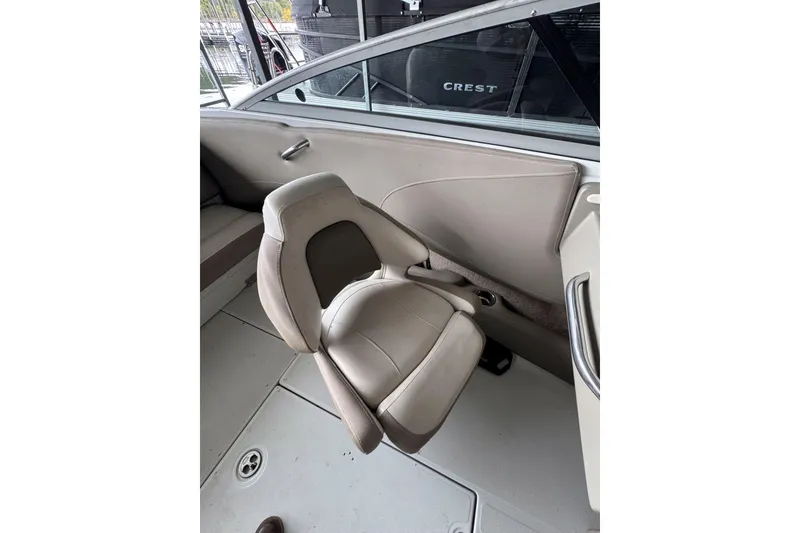 Slide: The Image of 2019 Crownline 215 SS boat interior with beige seating and sleek design. - 14
