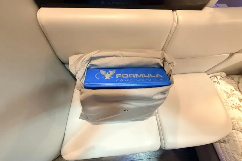 Slide: The Image of Blue Formula owner information folder on a white leather seat, 2017 Formula 350 Crossover Bowrider OB. - 39