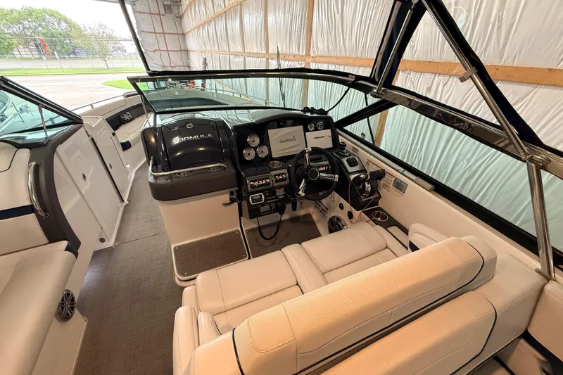 Slide: The Image of 2017 Formula 350 Crossover Bowrider OB interior with helm and seating area. - 19
