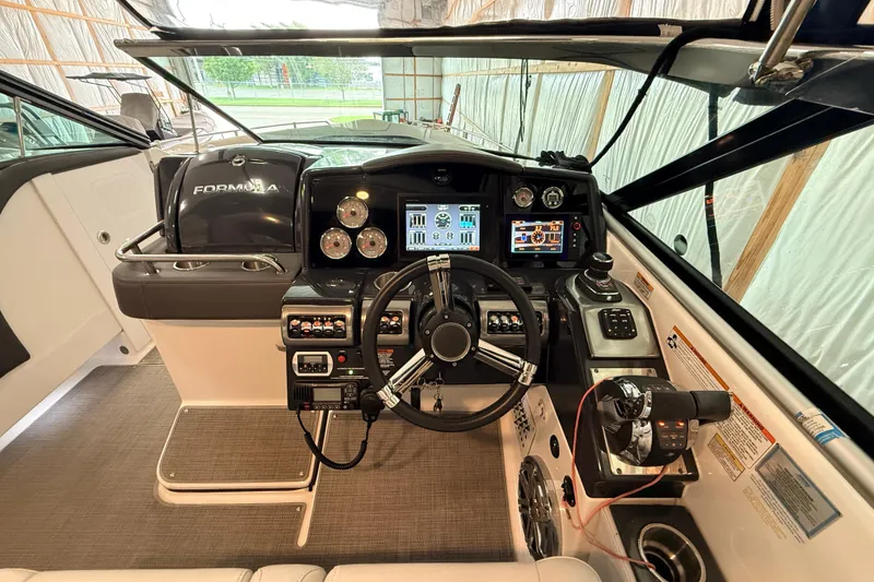 Slide: The Image of 2017 Formula 350 Crossover Bowrider OB cockpit with modern controls and navigation displays. - 11