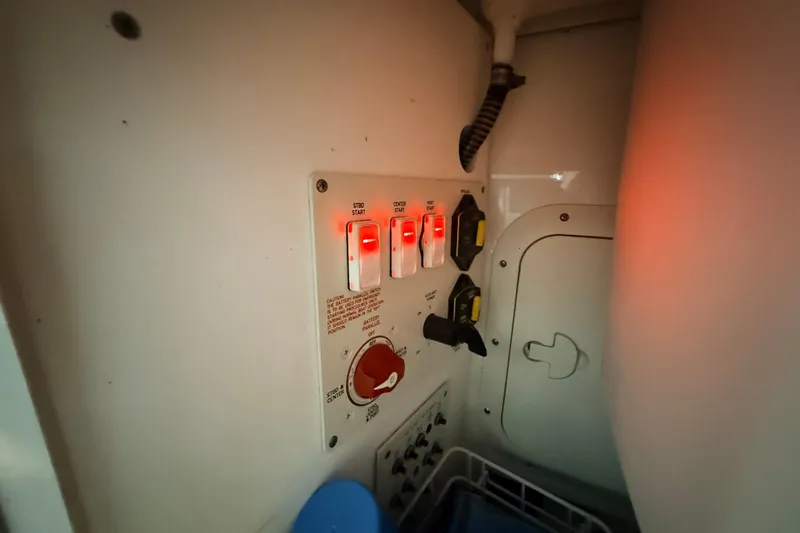 Slide: The Image of Control panel with illuminated switches on a 2017 Formula 350 Crossover Bowrider OB boat. - 23