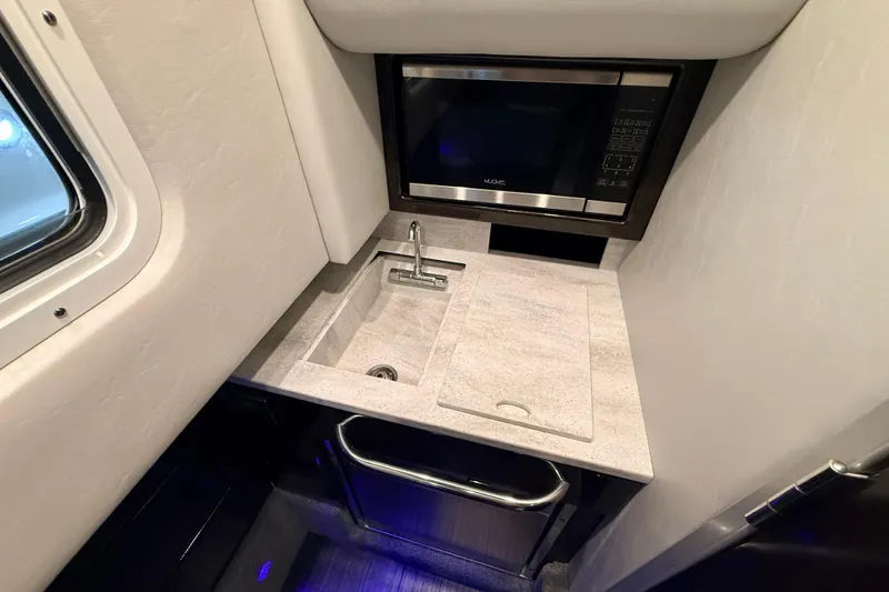 Slide: The Image of Compact kitchenette in 2017 Formula 350 Crossover Bowrider OB with sink and microwave. - 34