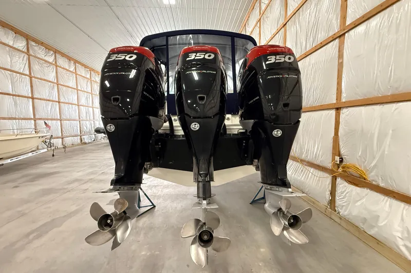 Slide: The Image of 2017 Formula 350 Crossover Bowrider OB with triple outboard engines in storage. - 10