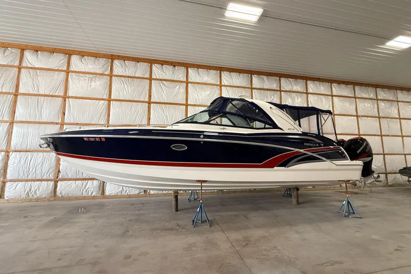 The Image of 2017 Formula 350 Crossover Bowrider OB in storage, blue and white exterior. - 1
