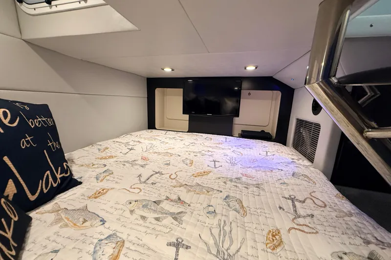 Slide: The Image of Cozy cabin interior of 2017 Formula 350 Crossover Bowrider OB with nautical-themed bedding. - 36