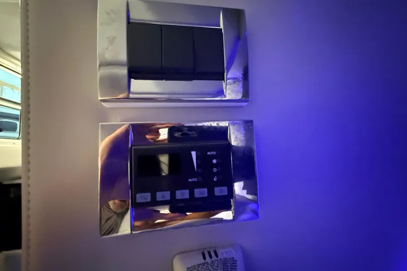 Slide: The Image of Control panel on a 2017 Formula 350 Crossover Bowrider OB, illuminated in blue light. - 35