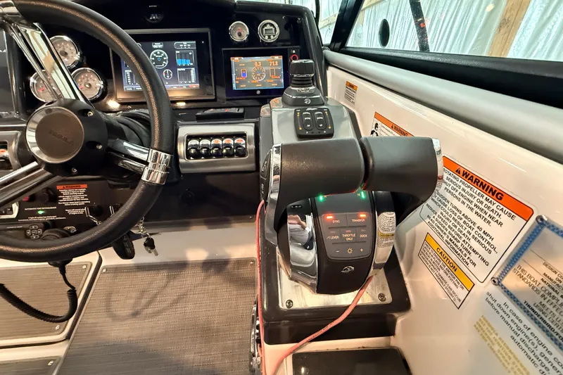 Slide: The Image of Cockpit controls of a 2017 Formula 350 Crossover Bowrider OB with steering wheel and digital displays. - 16