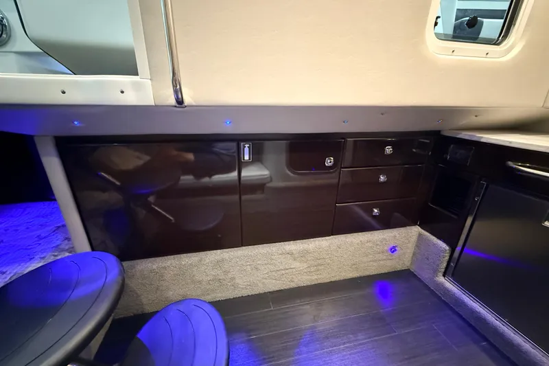 Slide: The Image of Interior of a 2017 Formula 350 Crossover Bowrider OB, featuring sleek cabinetry and ambient lighting. - 33