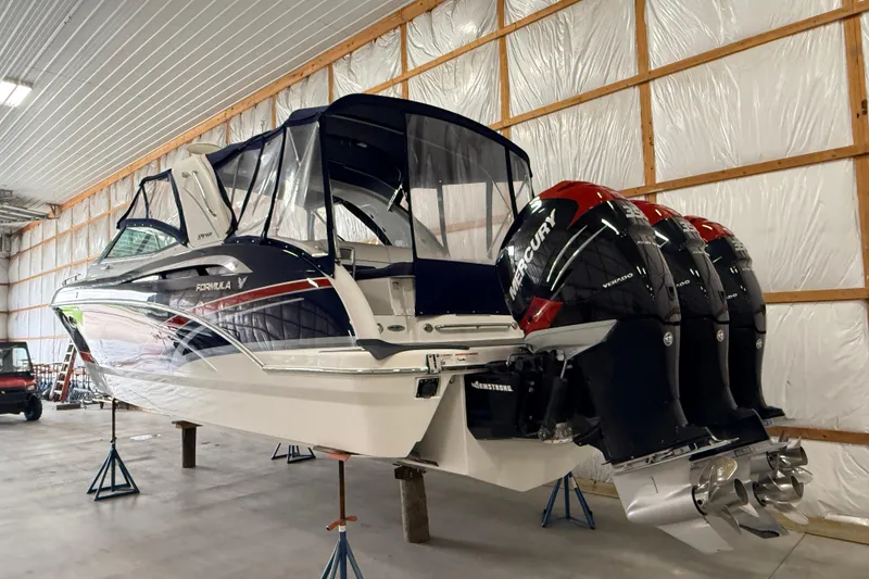 Slide: The Image of 2017 Formula 350 Crossover Bowrider OB with triple Mercury outboards in a storage facility. - 3