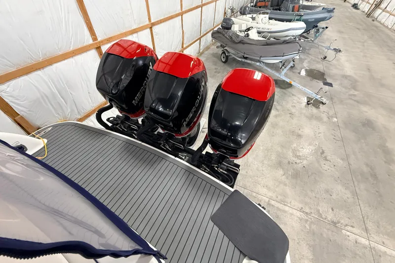 Slide: The Image of 2017 Formula 350 Crossover Bowrider OB with triple outboard engines in a storage facility. - 9