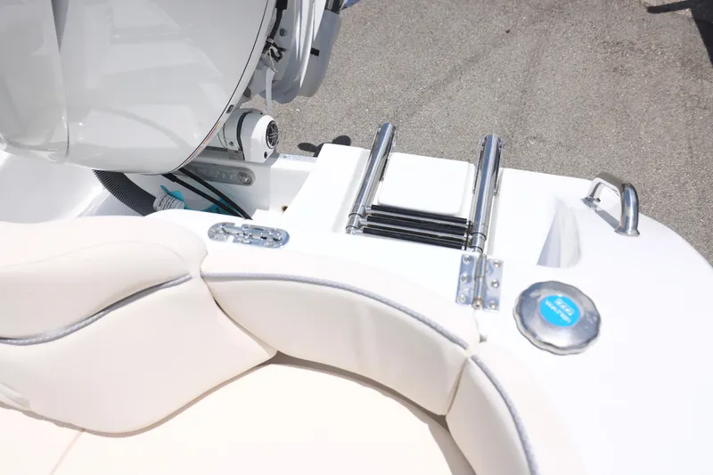 Slide: The Image of 2027 Sea Hunt Ultra 219 boat with swim ladder and engine details. - 25