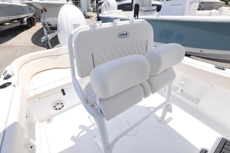 Slide: The Image of 2027 Sea Hunt Ultra 219 boat interior with white cushioned seating and sleek design. - 24