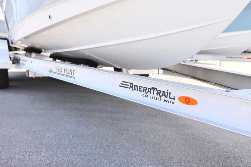 Slide: The Image of Sea Hunt Ultra 219 boat on AmeraTrail trailer, 2027 model, parked on pavement. - 5