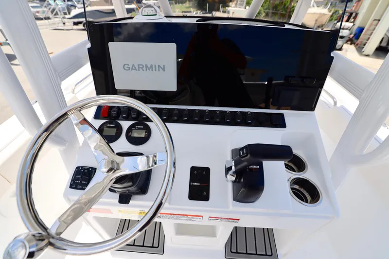 Slide: The Image of Steering console of 2027 Sea Hunt Ultra 219 with Garmin display and Yamaha controls. - 21