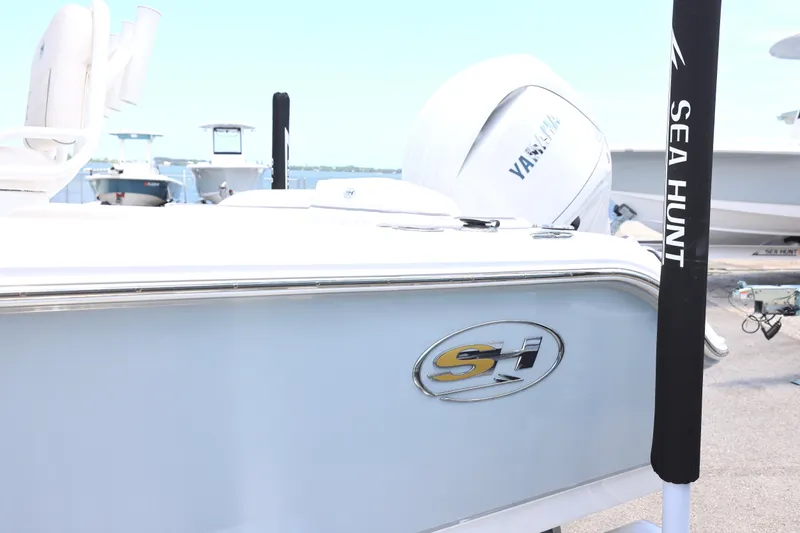 Slide: The Image of 2027 Sea Hunt Ultra 219 boat with Yamaha engine, docked at marina. - 12