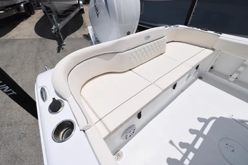 Slide: The Image of 2027 Sea Hunt Ultra 219 boat interior with cushioned seating and cup holders. - 19