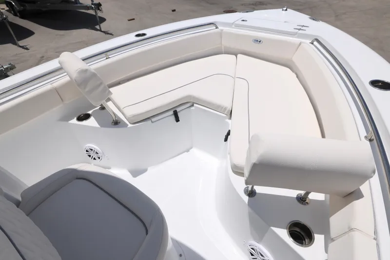 Slide: The Image of 2027 Sea Hunt Ultra 219 boat interior with white cushioned seating and stainless steel fixtures. - 2