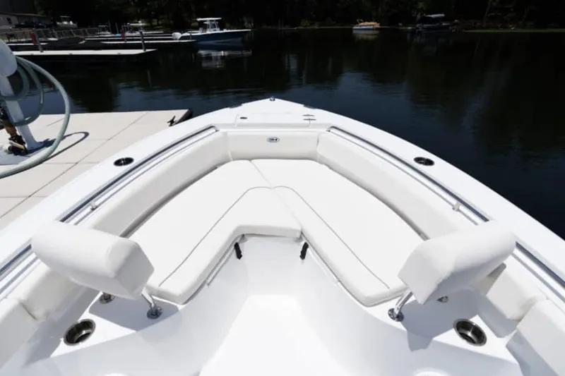 Slide: The Image of Manufacturer Provided Image: 2026 Sea Hunt Ultra 219 boat interior with white seating, docked by calm water. - 37