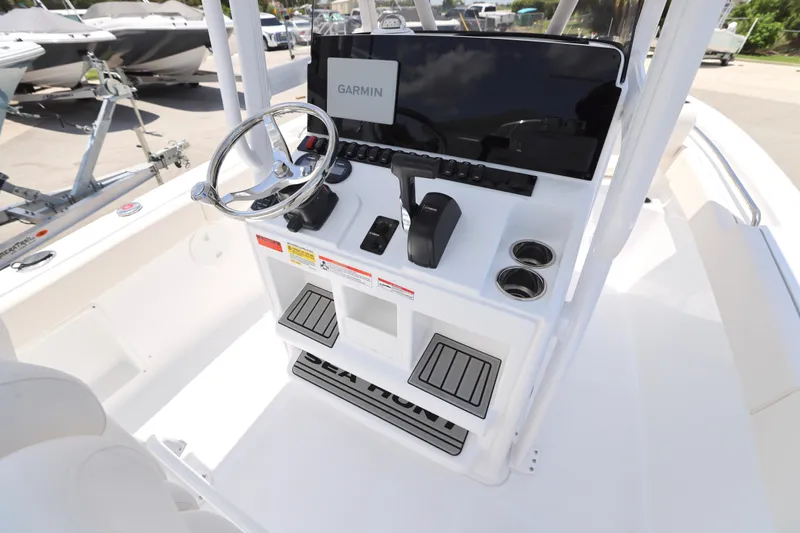 Slide: The Image of 2027 Sea Hunt Ultra 219 boat console with Garmin navigation and steering wheel. - 6