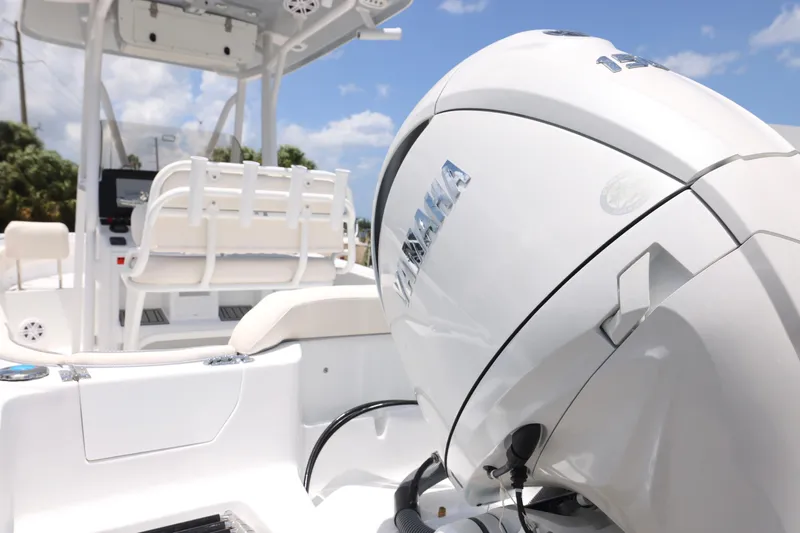 Slide: The Image of 2027 Sea Hunt Ultra 219 boat with Yamaha outboard motor, white interior, sunny day. - 29