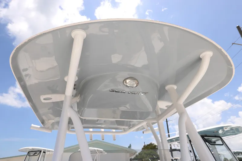 Slide: The Image of 2027 Sea Hunt Ultra 219 boat canopy against a bright blue sky. - 17