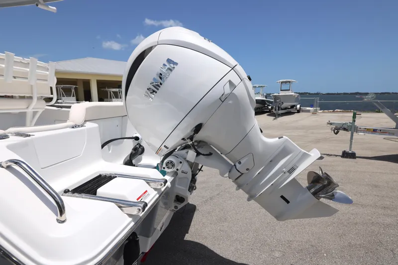 Slide: The Image of 2027 Sea Hunt Ultra 219 boat with Yamaha outboard motor, docked near the waterfront. - 28