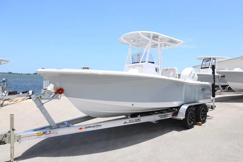 Slide: The Image of 2027 Sea Hunt Ultra 219 boat on trailer by the waterfront. - 8