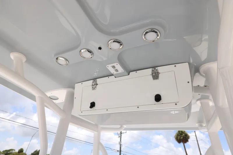 Slide: The Image of 2027 Sea Hunt Ultra 219 boat ceiling with built-in lights and storage compartment. - 20